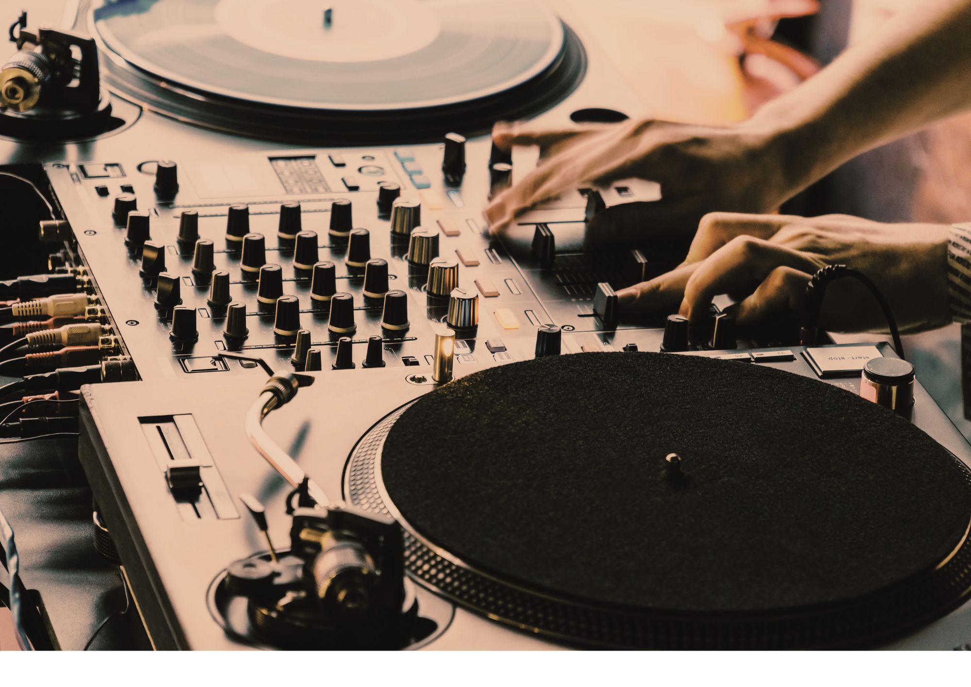 Hands mixing on DJ turntables during a RHYTHMSTATE class